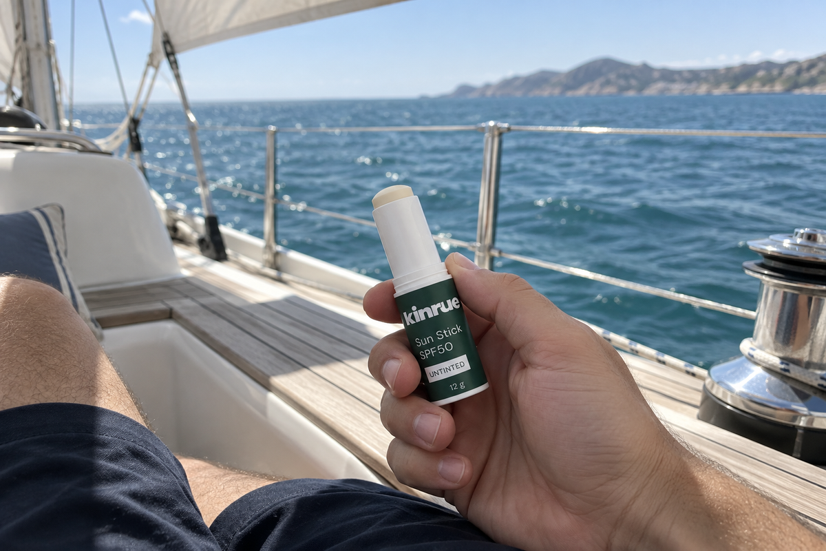Kinrue Sun Stick SPF50 held on a sailing yacht